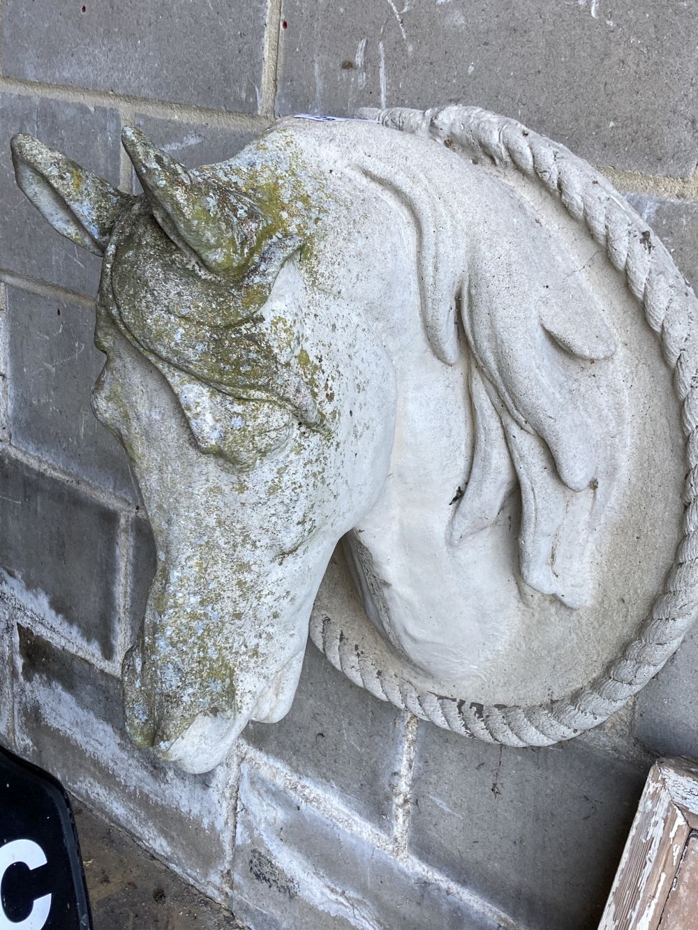 A weathered reconstituted stone model of a horses head, height 60cm